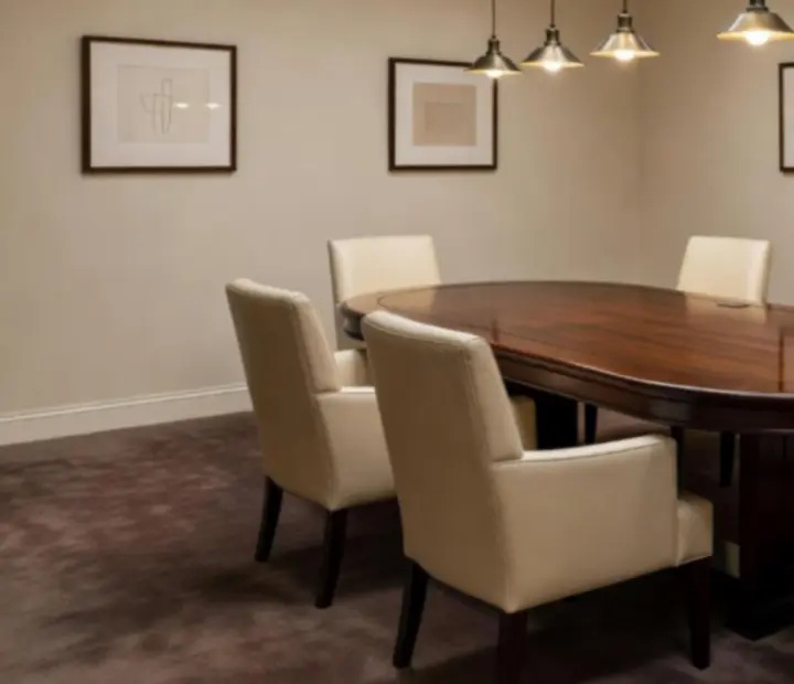 Secluded offline poker salon with linen-dressed tables, upholstered chairs and warm lighting.